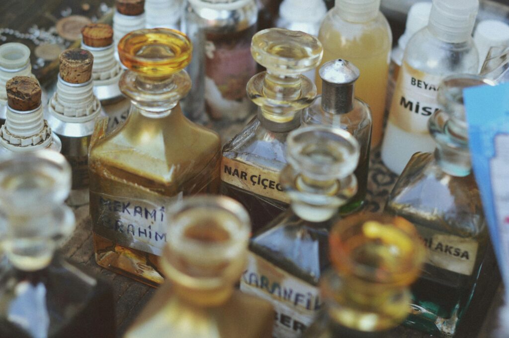 Collection of vintage glass perfume bottles with various labels in a close-up view.